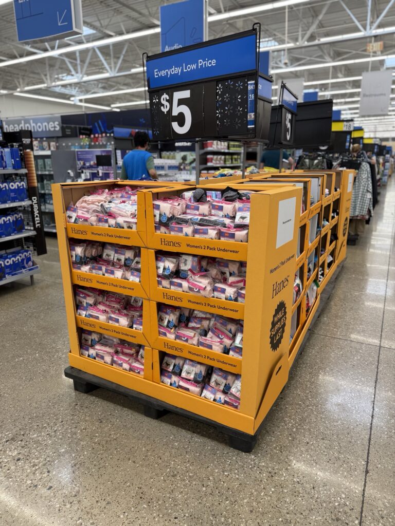 Custom floor-standing dump bin POS display used in retail store